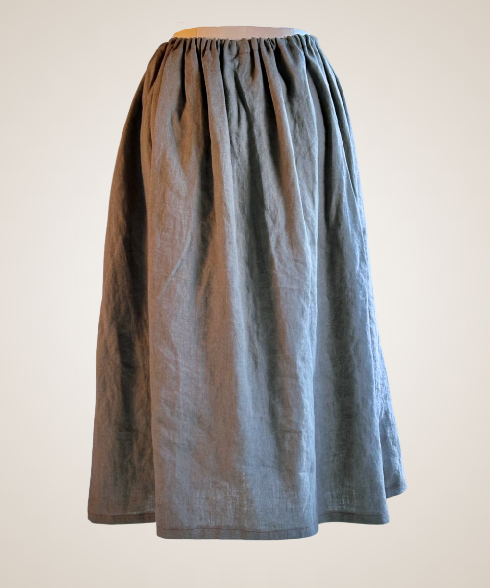A gray long-sleeve button-up shirt jacket with a black geometric diamond pattern, displayed on a mannequin torso against a light beige background.